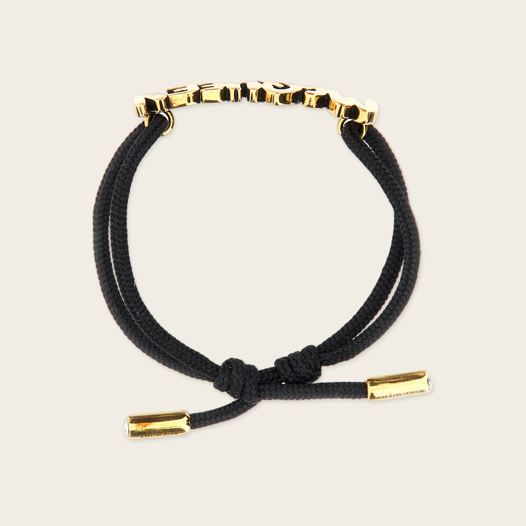 Alexander McQueen Graffiti Bracelet Alexander McQueen Graffiti Logo Bracelet with gold plaque logo in gold, two crystals inside both ends of the bracelet gives the luxury touch.