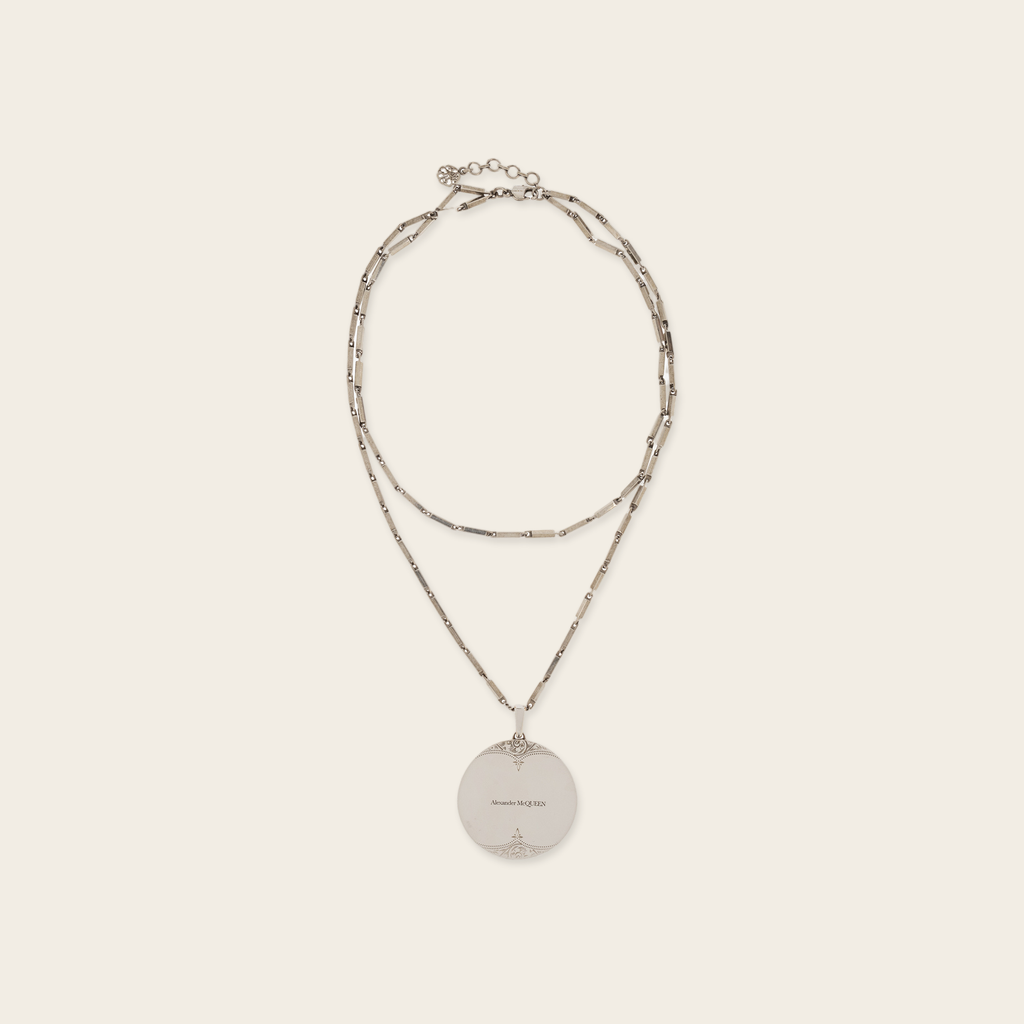 Alexander McQueen Oversized Medallion Necklace Alexander McQueen Oversized Medallion Necklace with double chain, logo engraved Medallion with aged look. Composition Brass