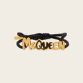 Alexander McQueen Graffiti Bracelet Alexander McQueen Graffiti Logo Bracelet with gold plaque logo in gold, two crystals inside both ends of the bracelet gives the luxury touch.