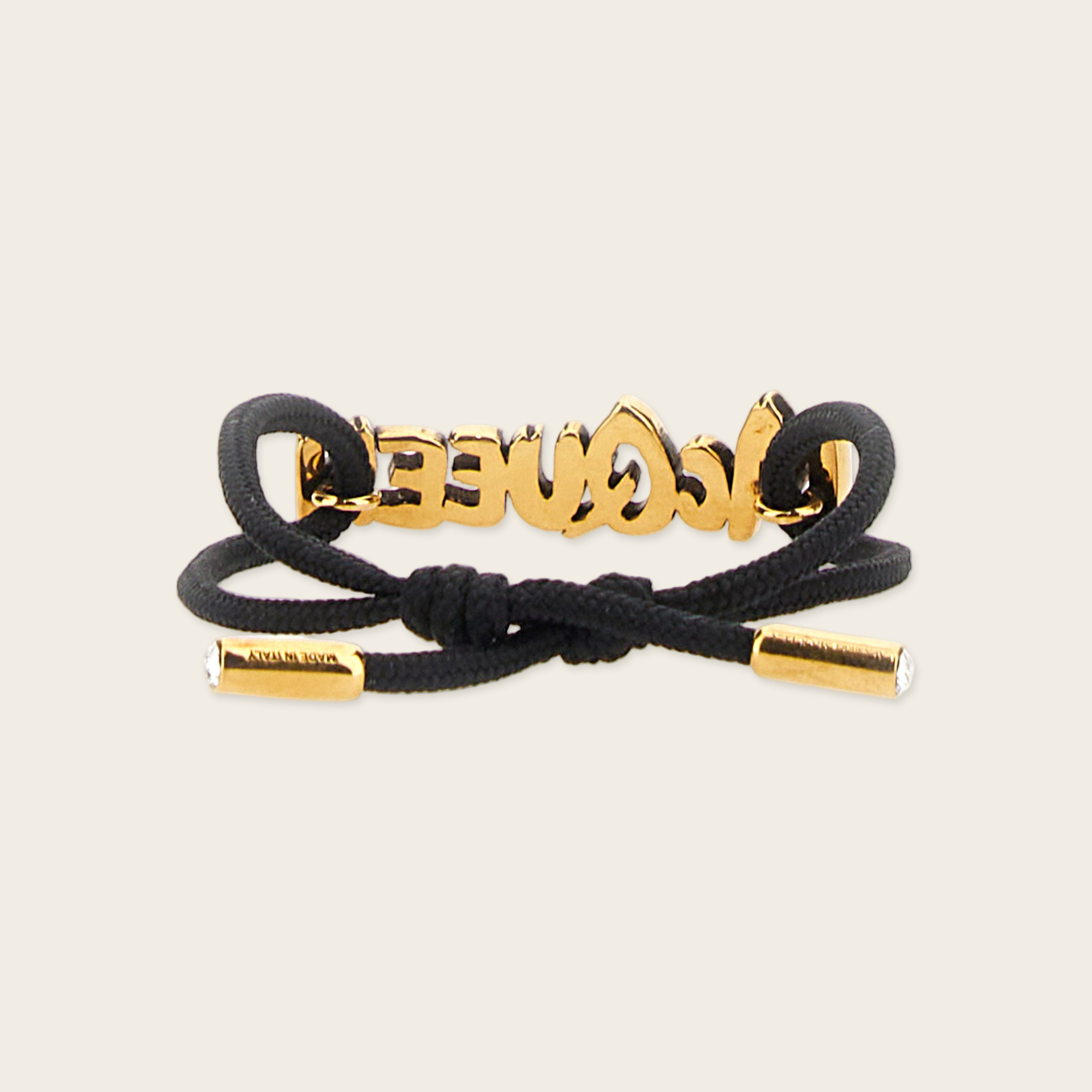 Alexander McQueen Graffiti Bracelet Alexander McQueen Graffiti Logo Bracelet with gold plaque logo in gold, two crystals inside both ends of the bracelet gives the luxury touch.