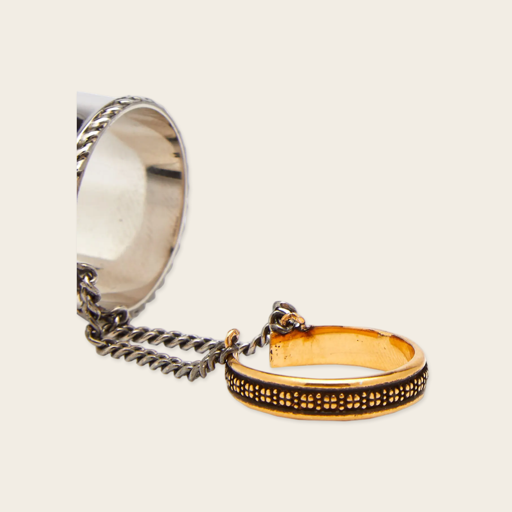 Alexander McQueen Chained Rings Alexander McQueen Chained double ring with logo engraved Silver and aged yellow. Composition Brass